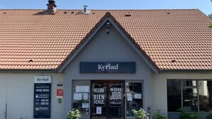 A building with a tiled roof and a sign reading "Kyriad" above the entrance. - KYRIAD Sedan (Sedan)