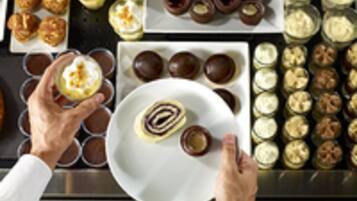 A variety of desserts on a tray, including pastries and small cakes.