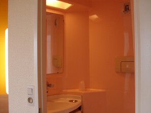 A bathroom with a sink, mirror, and toilet. - Premiere Classe Hotel Liege (Liege)
