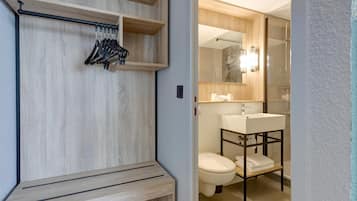 A modern bathroom with a wooden vanity, a sink, and a toilet.