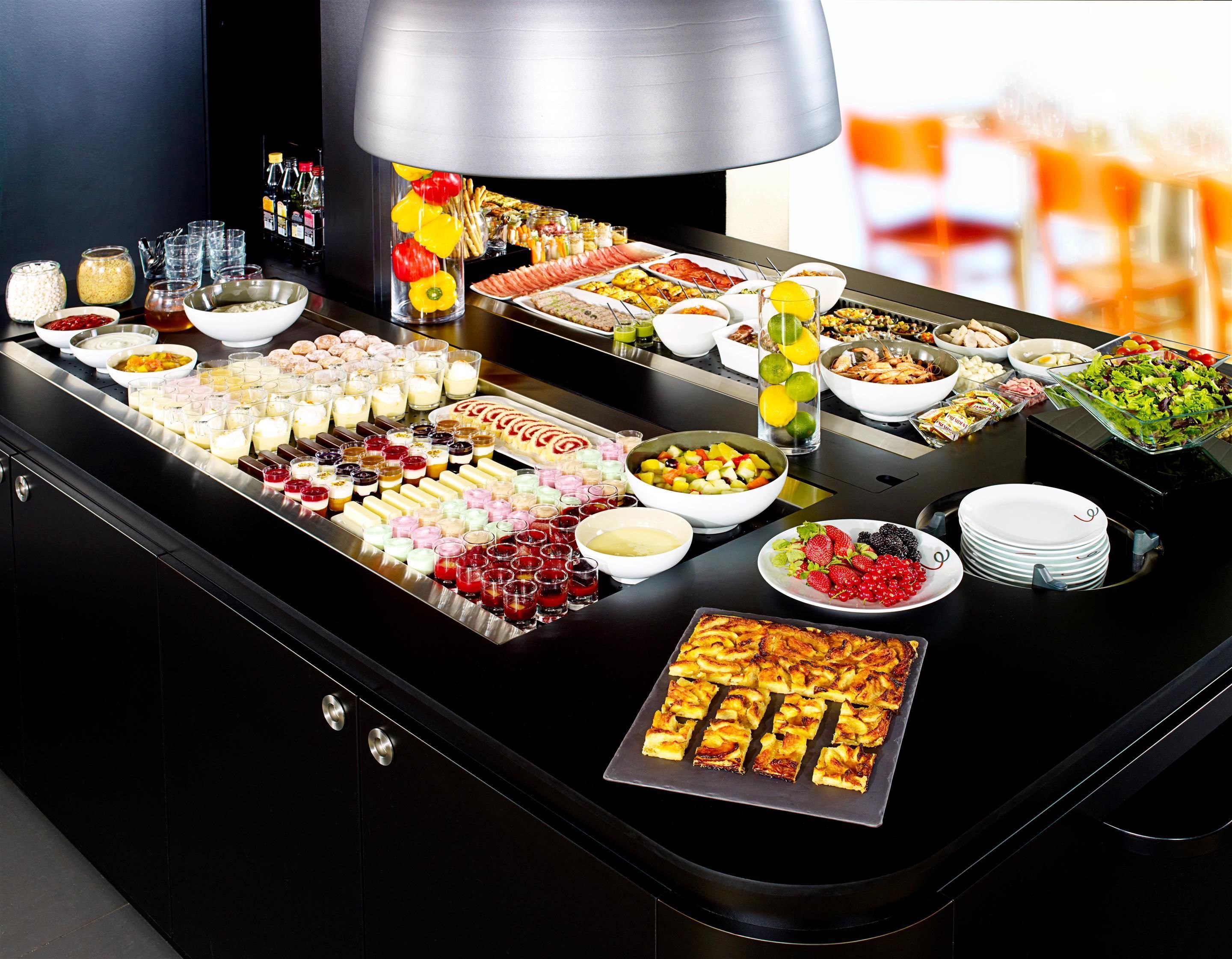 A buffet with various food items and beverages.