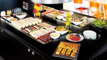 A buffet with various food items and beverages.