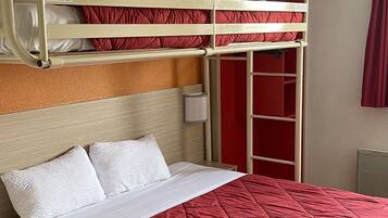 Habitación con literas, un edredón acolchado rojo, almohadas blancas y un cabecero de madera.