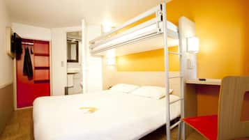 A bunk bed with a desk and chair, a red coat rack, and a bathroom visible through an open door.