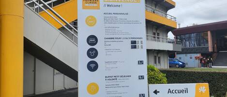 A welcome sign for Premiere Classe Hotels with information on room types, amenities, and breakfast prices.