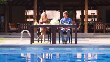 Enjoy meals and drinks in a tranquil setting under the pavilion adjacent to the pool.