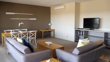 Deluxe Two Bedroom Apartment | Living area | 55-inch Smart TV with digital channels, TV, Netflix
