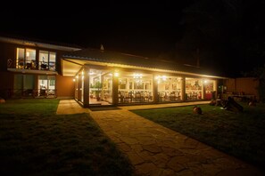 A well-lit building with a covered outdoor dining area and a visible balcony. - Casa Andina Premium Puno (Puno)