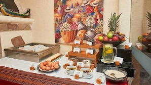 A breakfast buffet with various food items and a decorative wall piece. - Casa Andina Premium Puno (Puno)