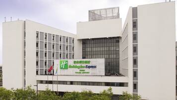 A modern building with a large billboard advertising Holiday Inn Express.