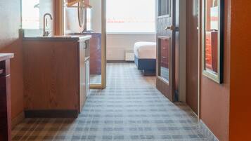 Escritorio, cortinas blackout y tabla de planchar con plancha