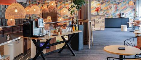A modern cafe with a wooden counter, wicker chairs, and hanging rattan lamps.