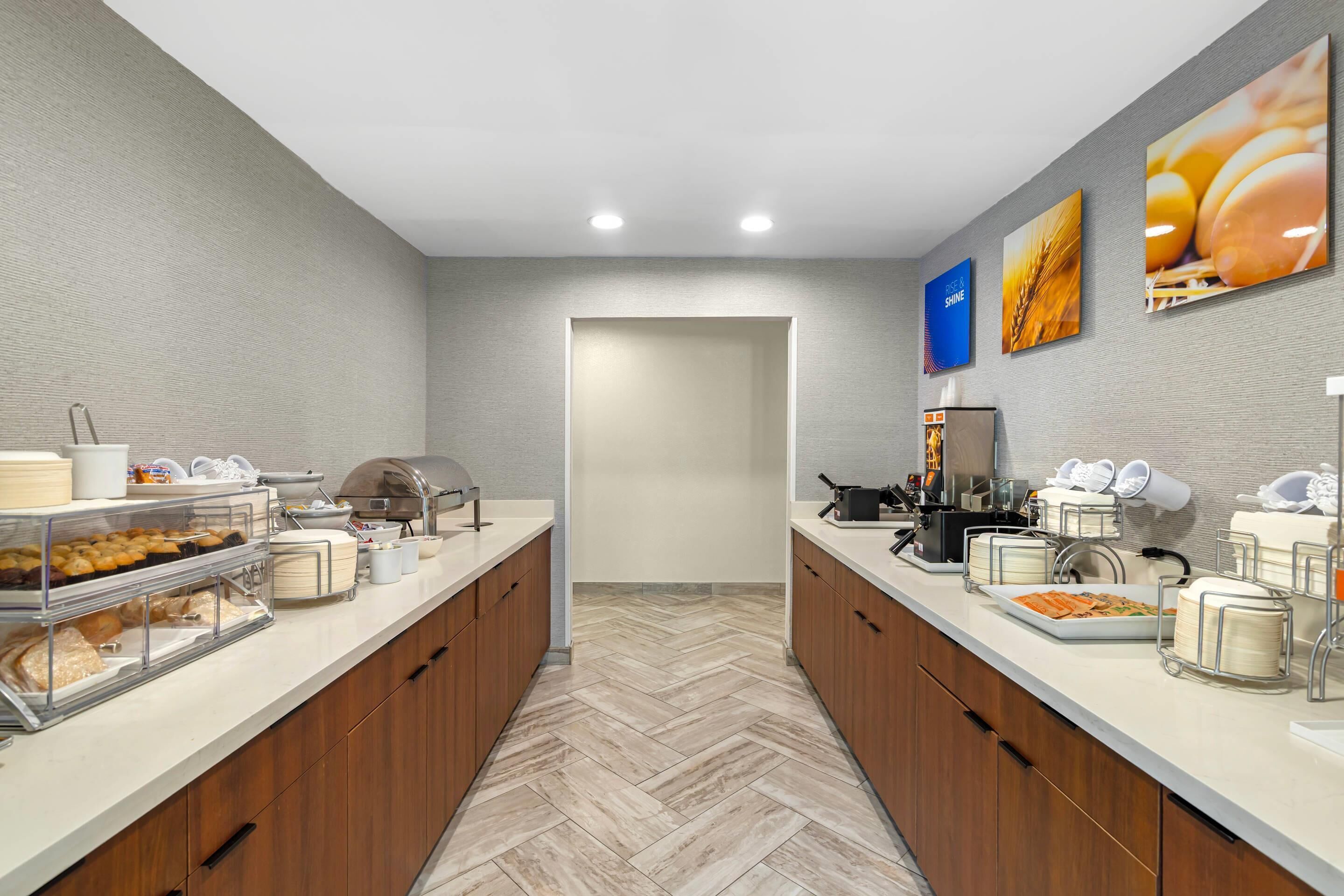 A modern kitchen with two counters, each with a variety of food items and kitchen appliances.