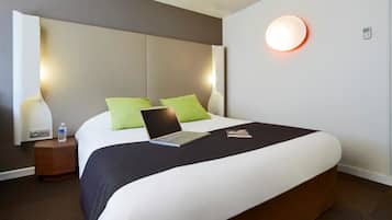 Premium bedding, desk, laptop workspace, blackout drapes