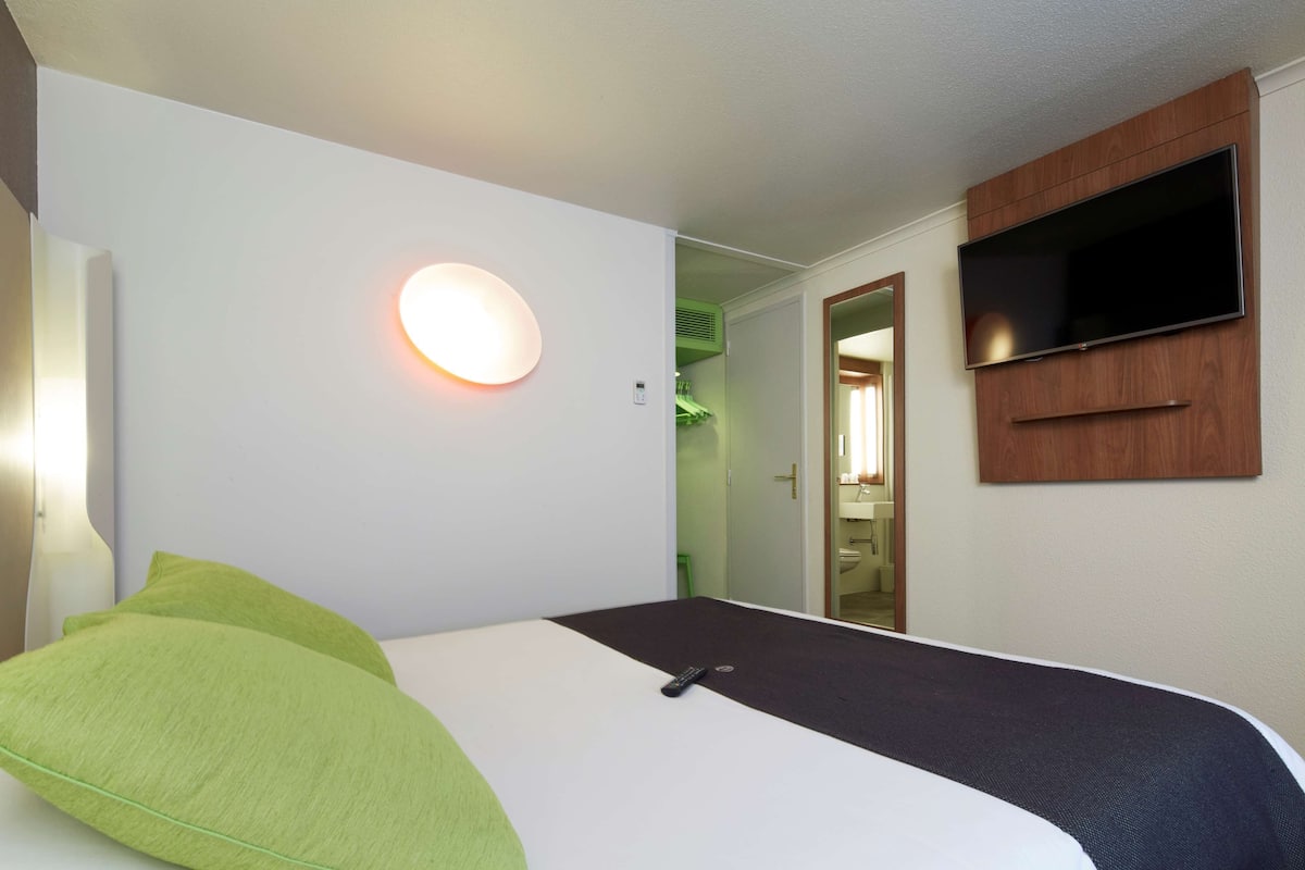 Premium bedding, desk, laptop workspace, blackout drapes