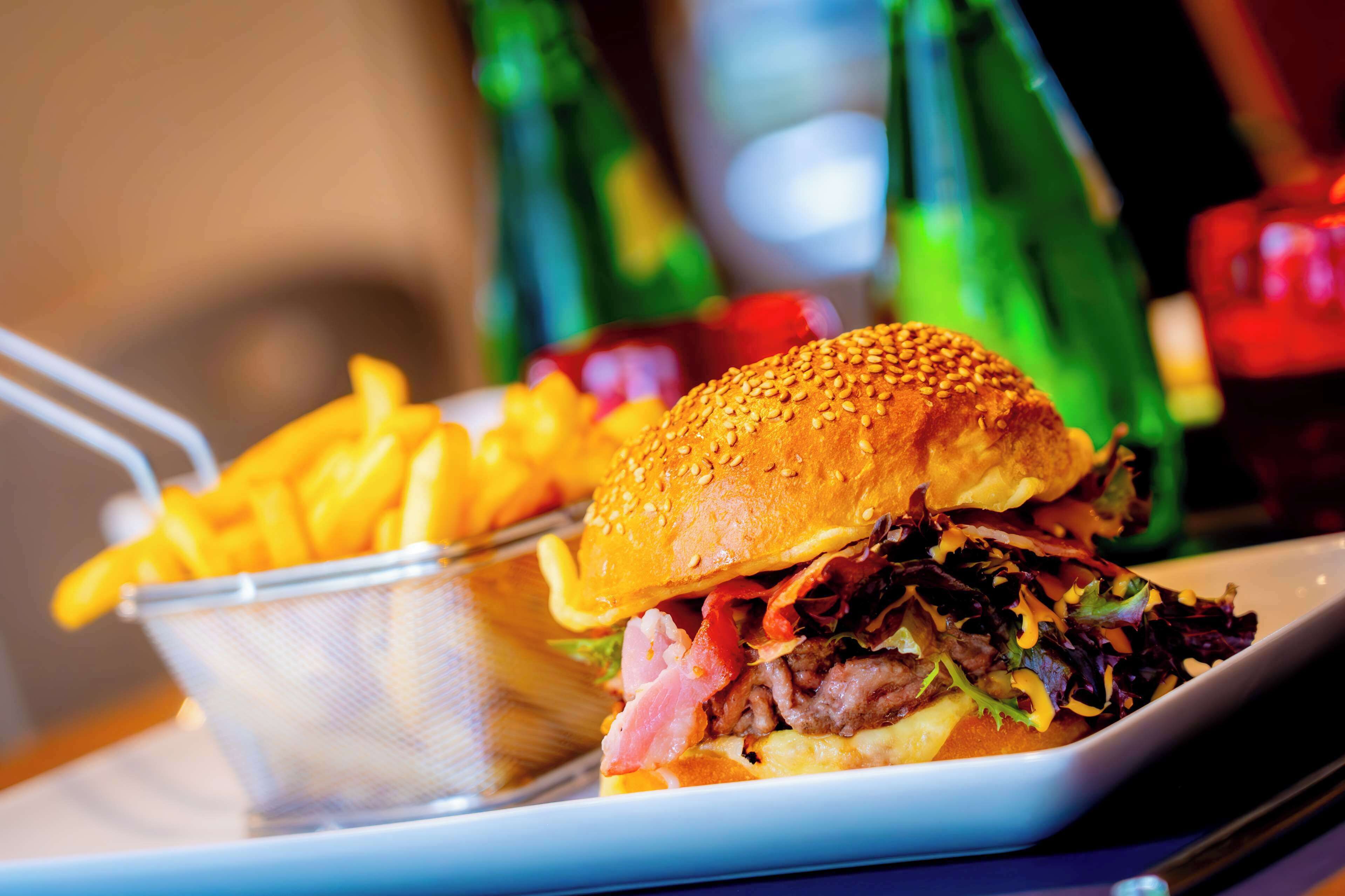 A meal consisting of a sandwich and fries on a plate.