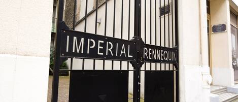 Una reja de metal negro con la inscripción 'IMPERIAL RENNEQUIN' grabada.