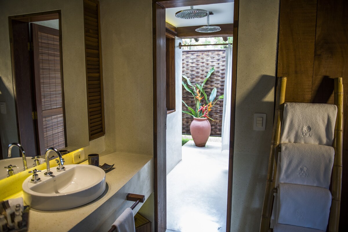 A bathroom with a sink, mirror, and towel rack.