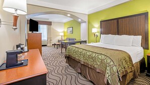 A hotel room with a bed, desk, and chair, a coffee machine, and a television. - La Quinta Inn & Suites by Wyndham Corpus Christi Airport (Corpus Christi)