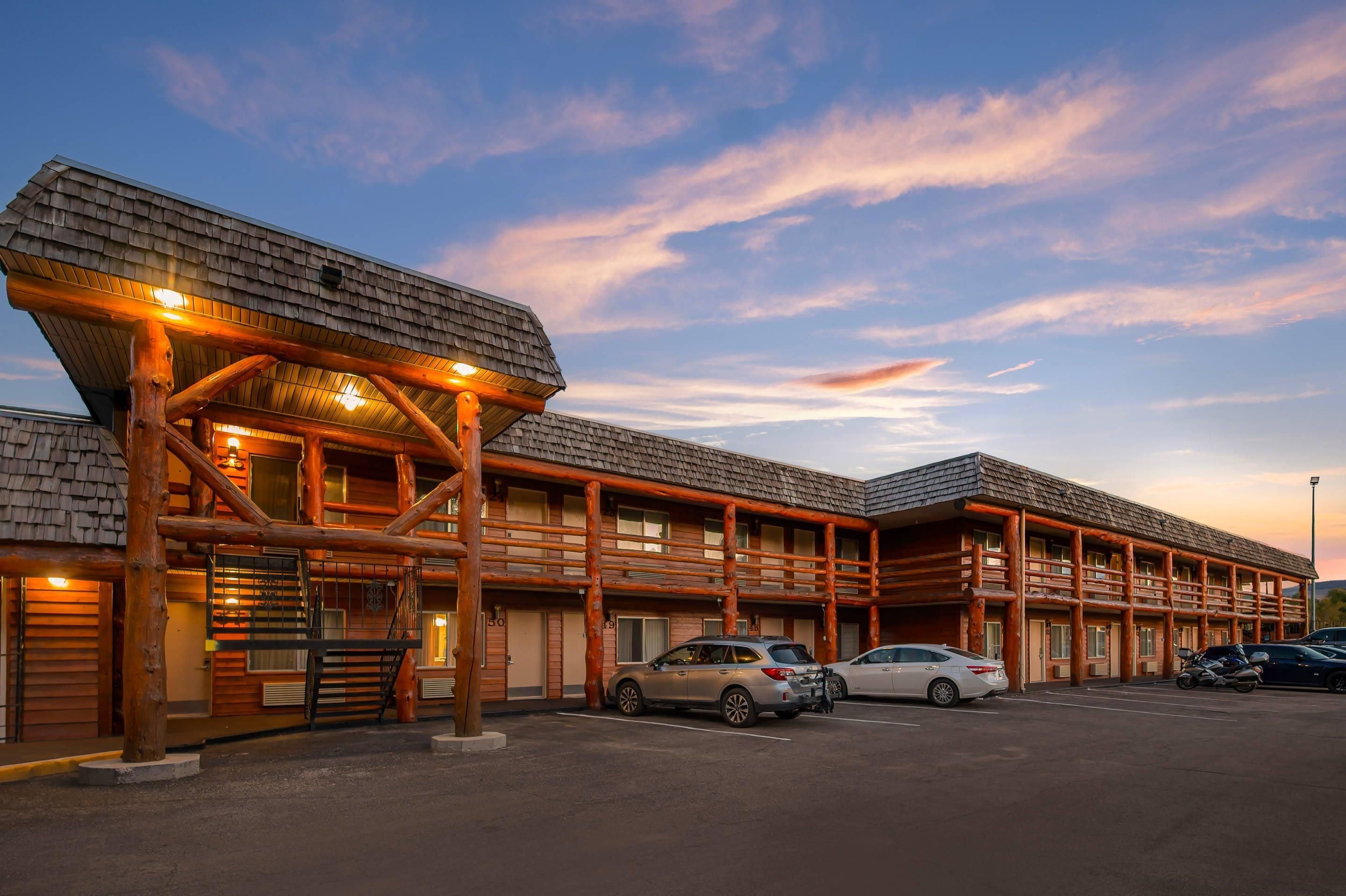 A log cabin-style building with multiple windows and a covered entrance.