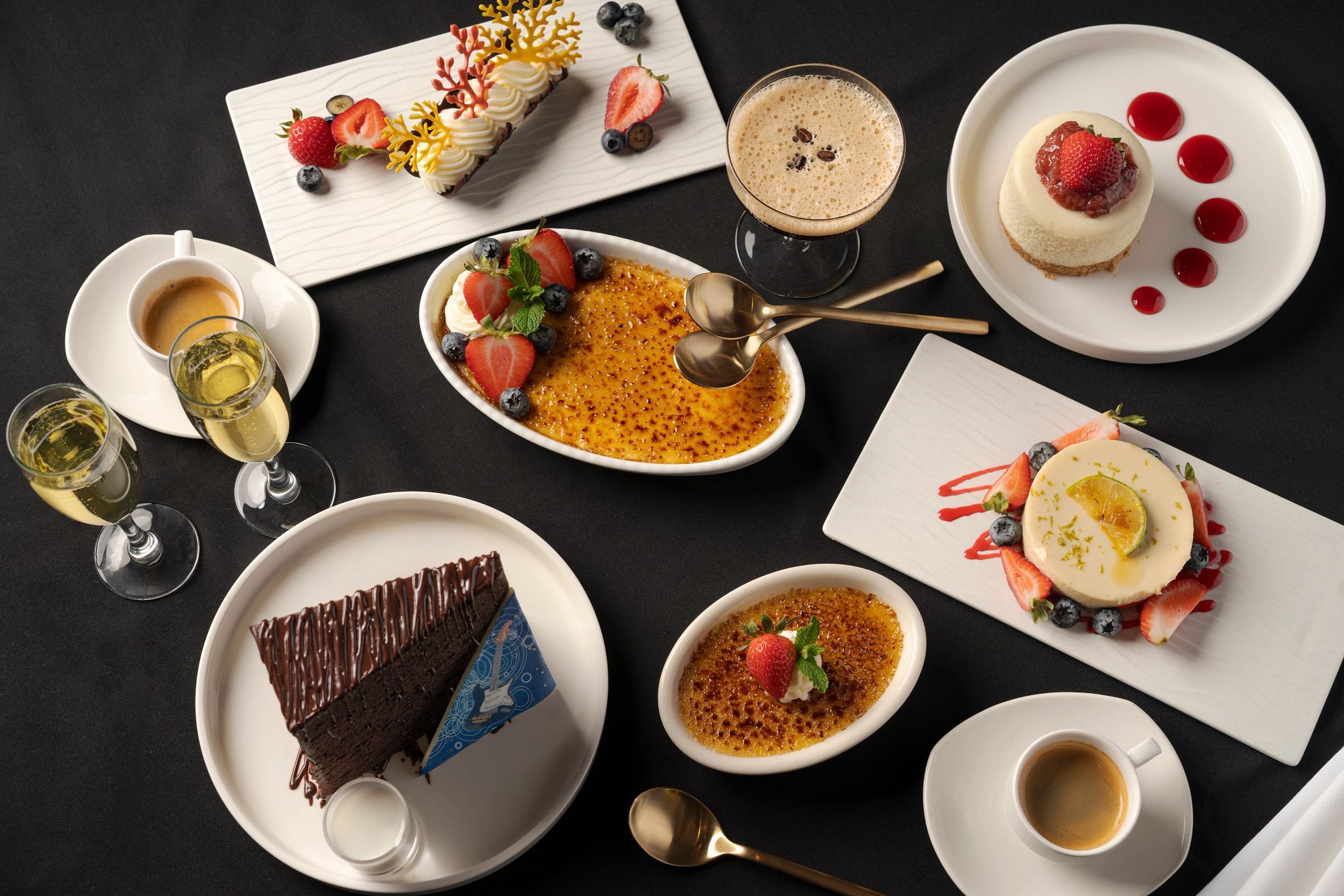 A variety of desserts and beverages on a table.