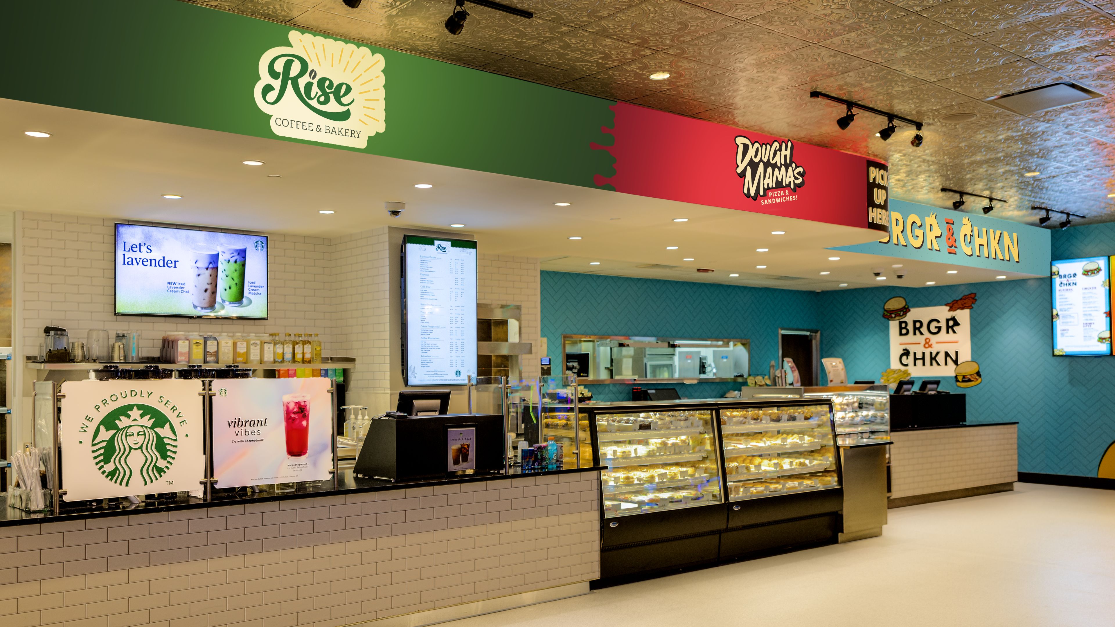 Een koffie- en bakkerijgedeelte met een Starbucks balie, een vitrine met donuts en een menubord.