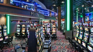 A casino with multiple slot machines and a poker area. - Hard Rock Hotel and Casino Tulsa (Catoosa)