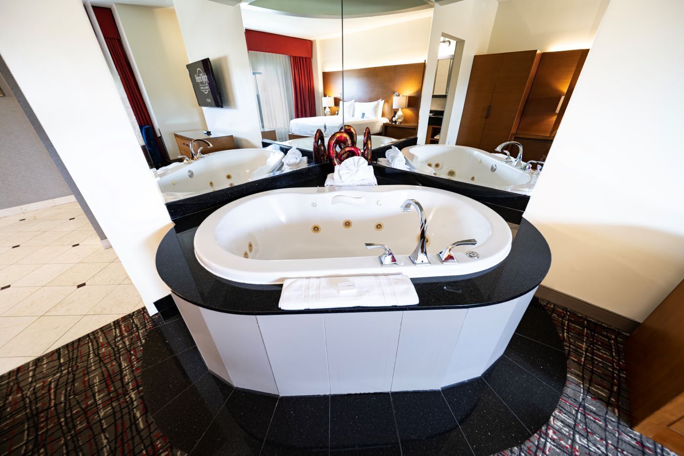 A modern bathroom with a freestanding bathtub, a large mirror, and a separate shower area.