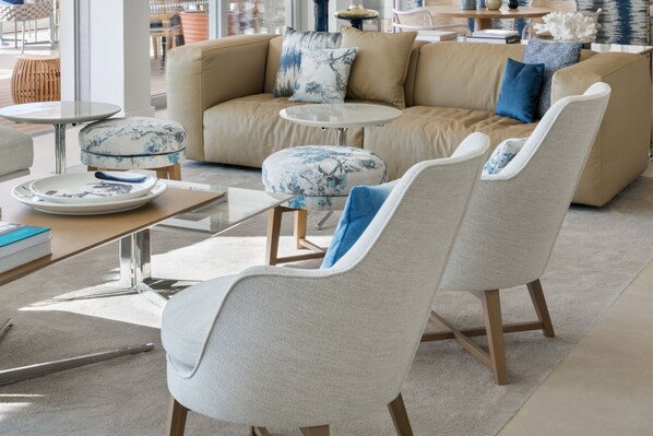 A modern living room with a beige sofa, two armchairs, a coffee table, and a side table. - Adriana Hvar Spa Hotel (Hvar)
