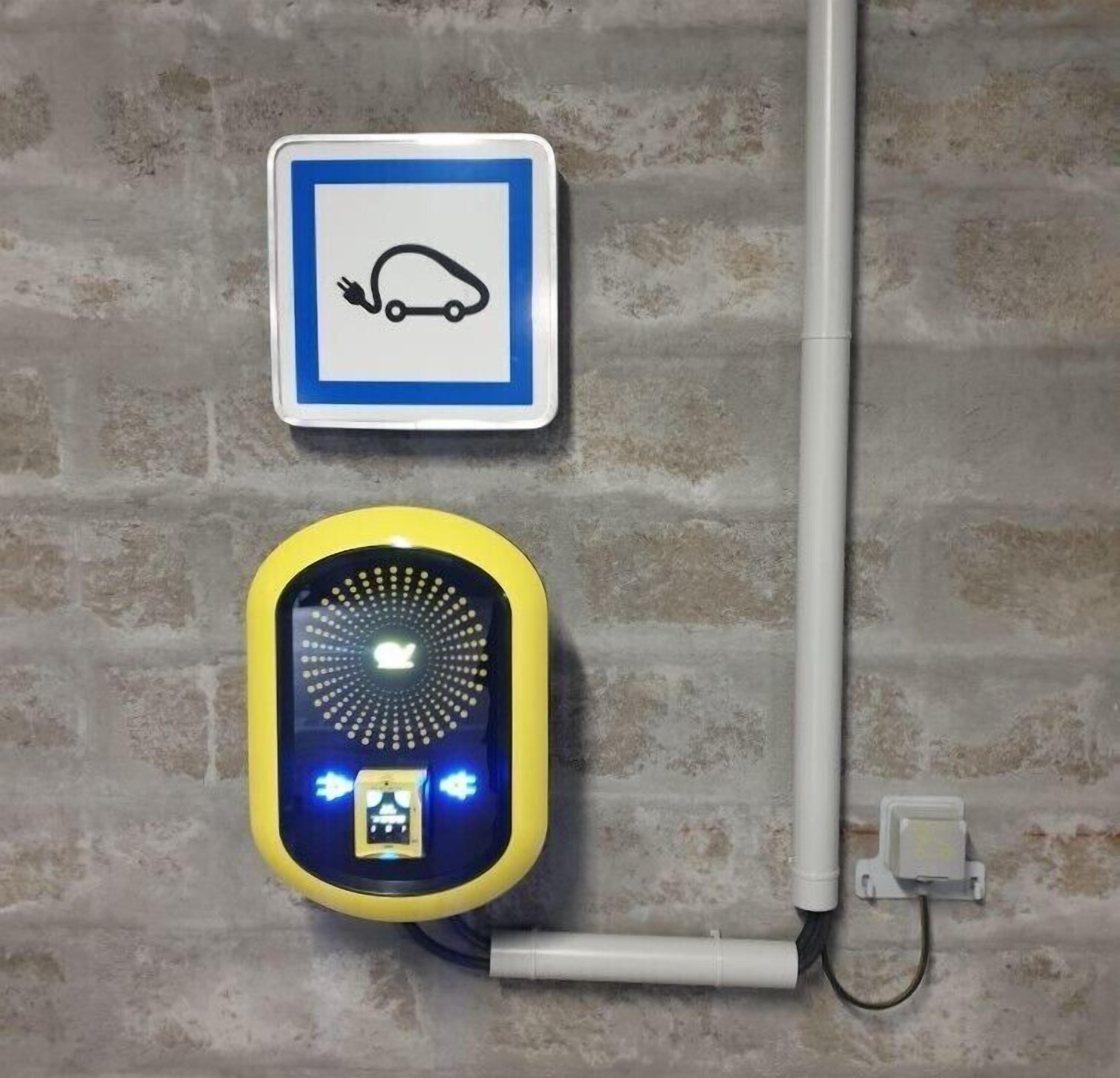 A wall-mounted device with a blue and yellow color scheme, a plug, and a power outlet.