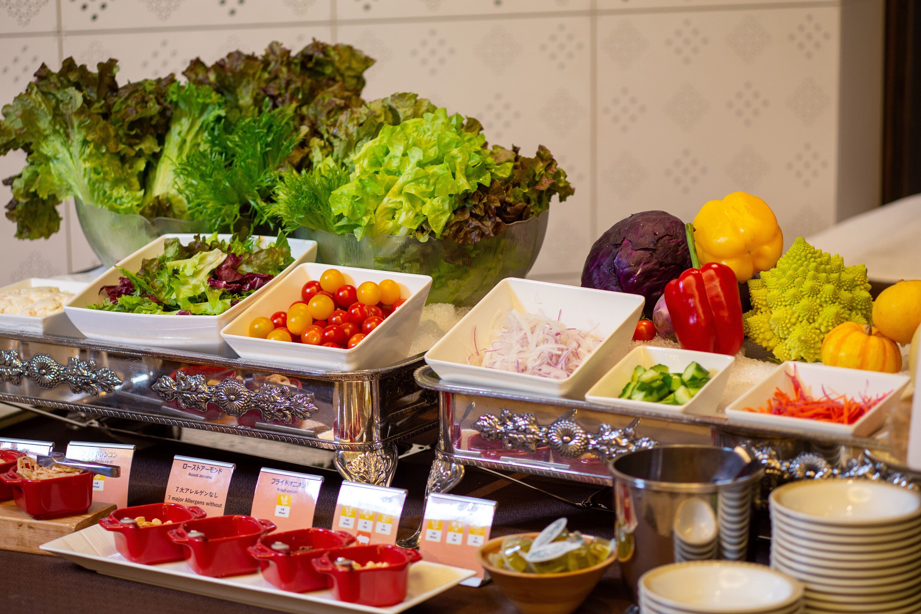 A buffet with various food items including salads, fruits, and vegetables.