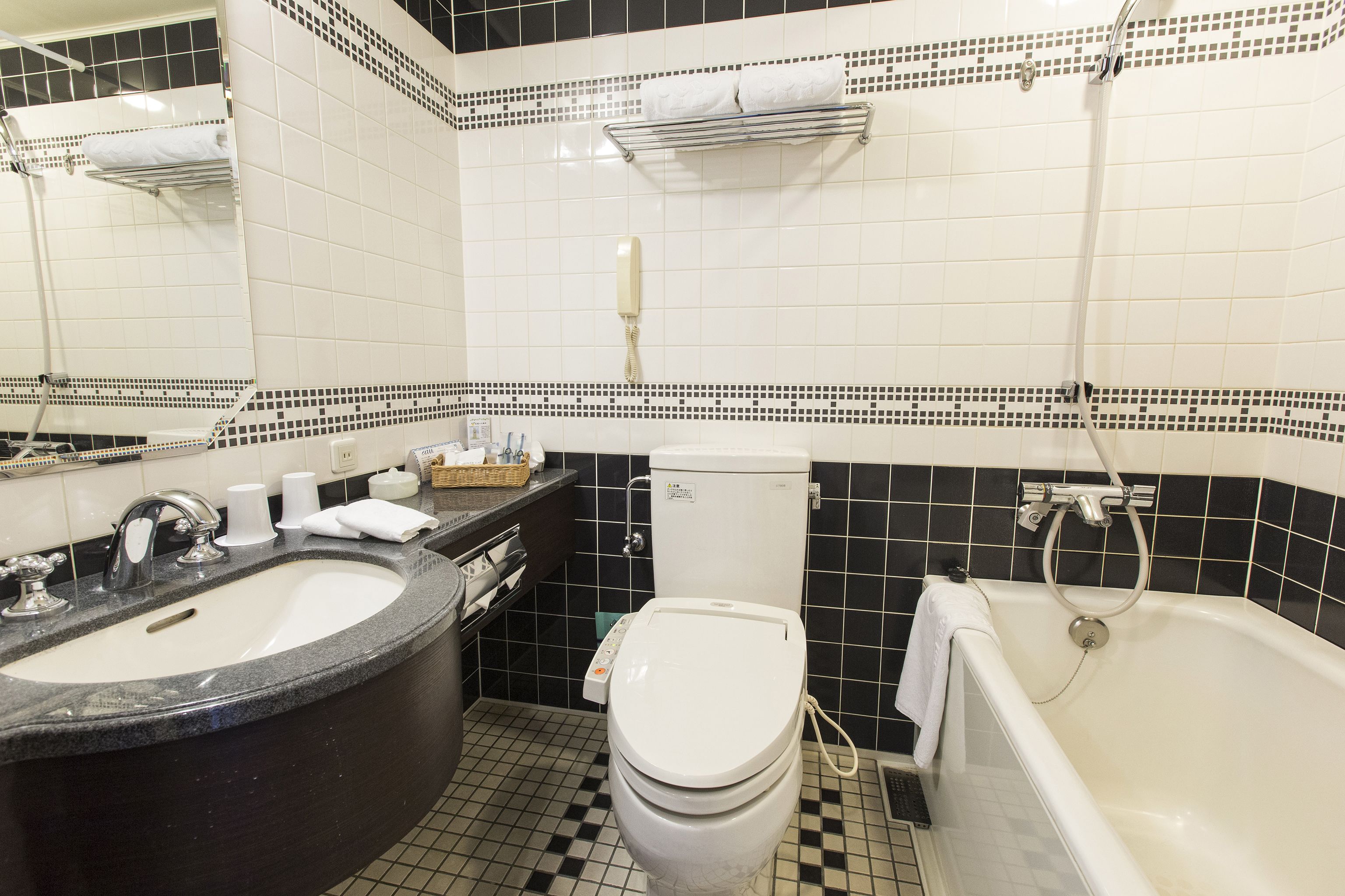 A bathroom with a sink, toilet, and bathtub.