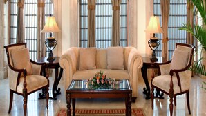 A formal room with a sofa, two chairs, a coffee table, and a lamp. - Park Plaza Jodhpur (Jodhpur)