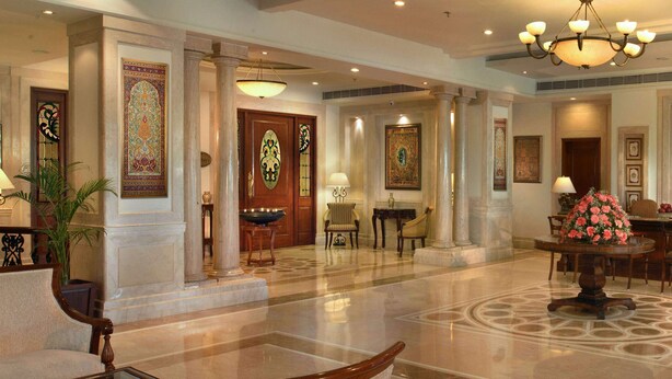 A spacious lobby with marble flooring, large columns, and traditional decor including a chandelier and framed artwork. - Park Plaza Jodhpur (Jodhpur)