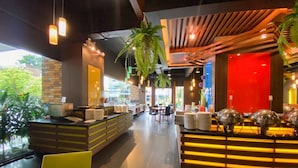A modern restaurant with a counter, seating area, and a red accent wall. - The Seasons Pattaya (Pattaya)