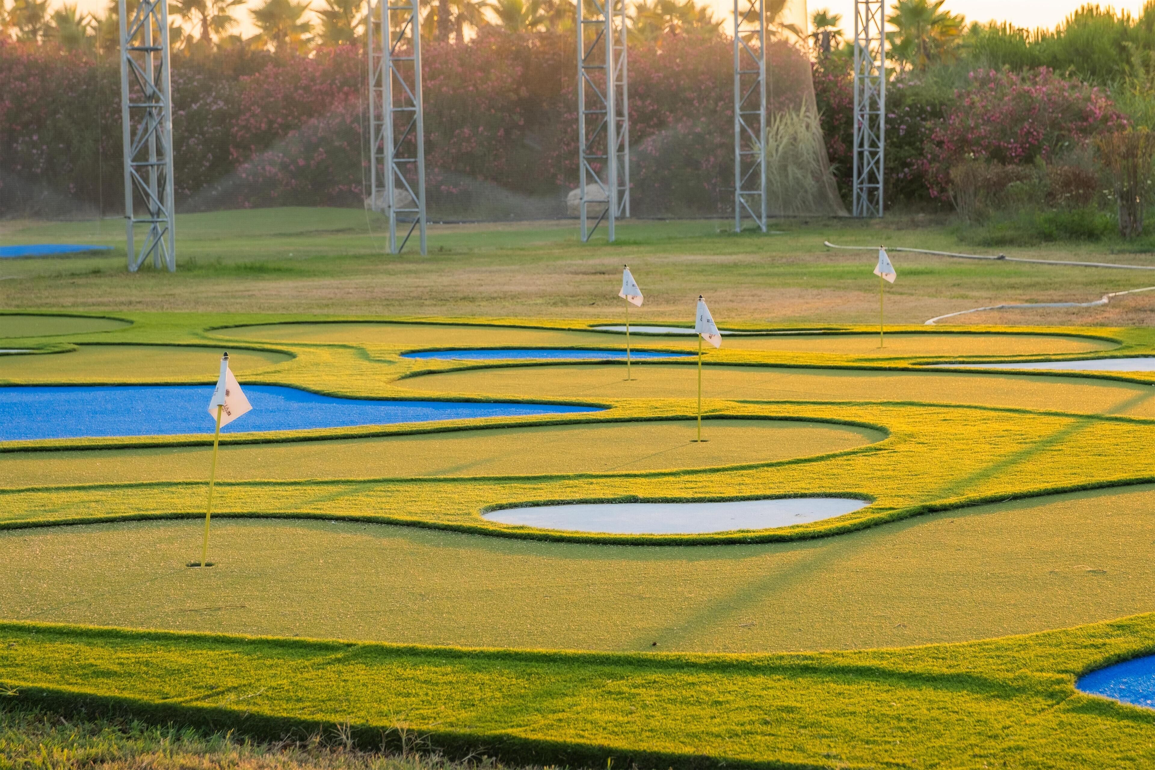 A golf course with multiple bunkers and water hazards.