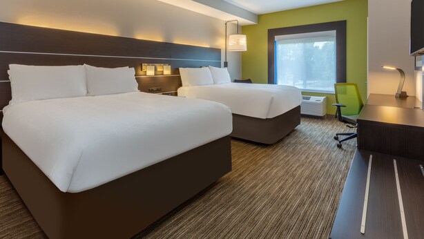 A hotel room with two beds, a desk, a chair, and a large window. - Holiday Inn Express Hotel & Suites Charlotte Arrowood by IHG (Charlotte)