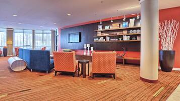 A lobby with a red accent wall, a large column, and a reception desk.