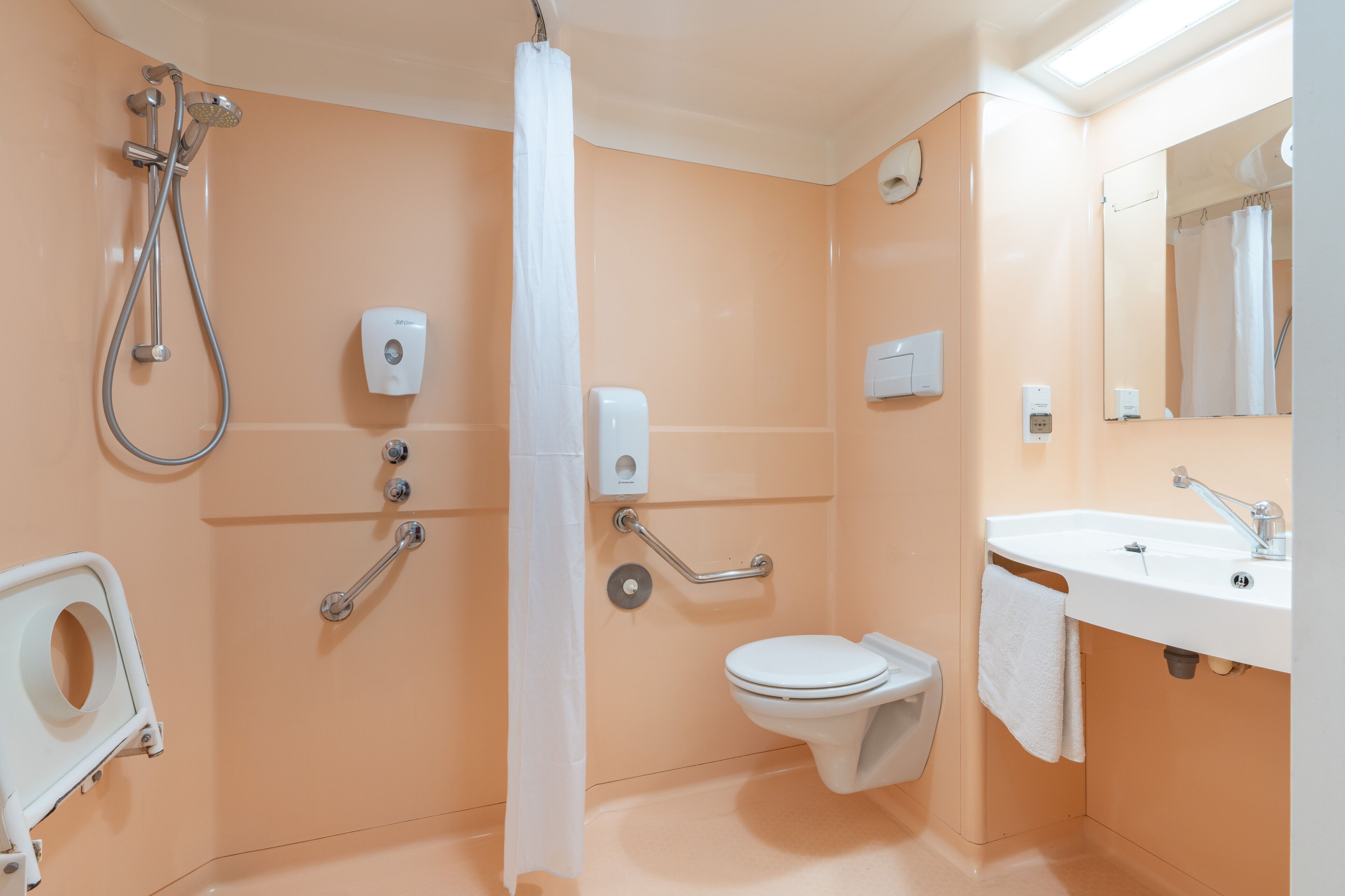 A bathroom with a toilet, sink, and shower.