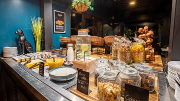 A buffet with various food items and a sign indicating 'fruits, seeds, dried fruits'.