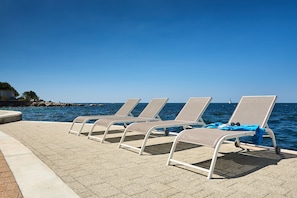 On the beach, sun loungers, beach umbrellas, beach bar