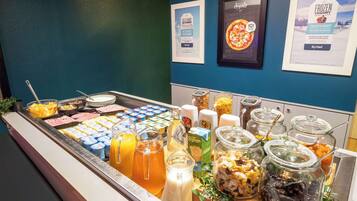 A breakfast buffet with various food items and beverages.
