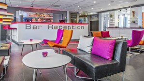 A bar reception area with a counter, chairs, tables, and a modern interior design. - Sure Hotel by Best Western Stockholm Alvsjo (Älvsjö)
