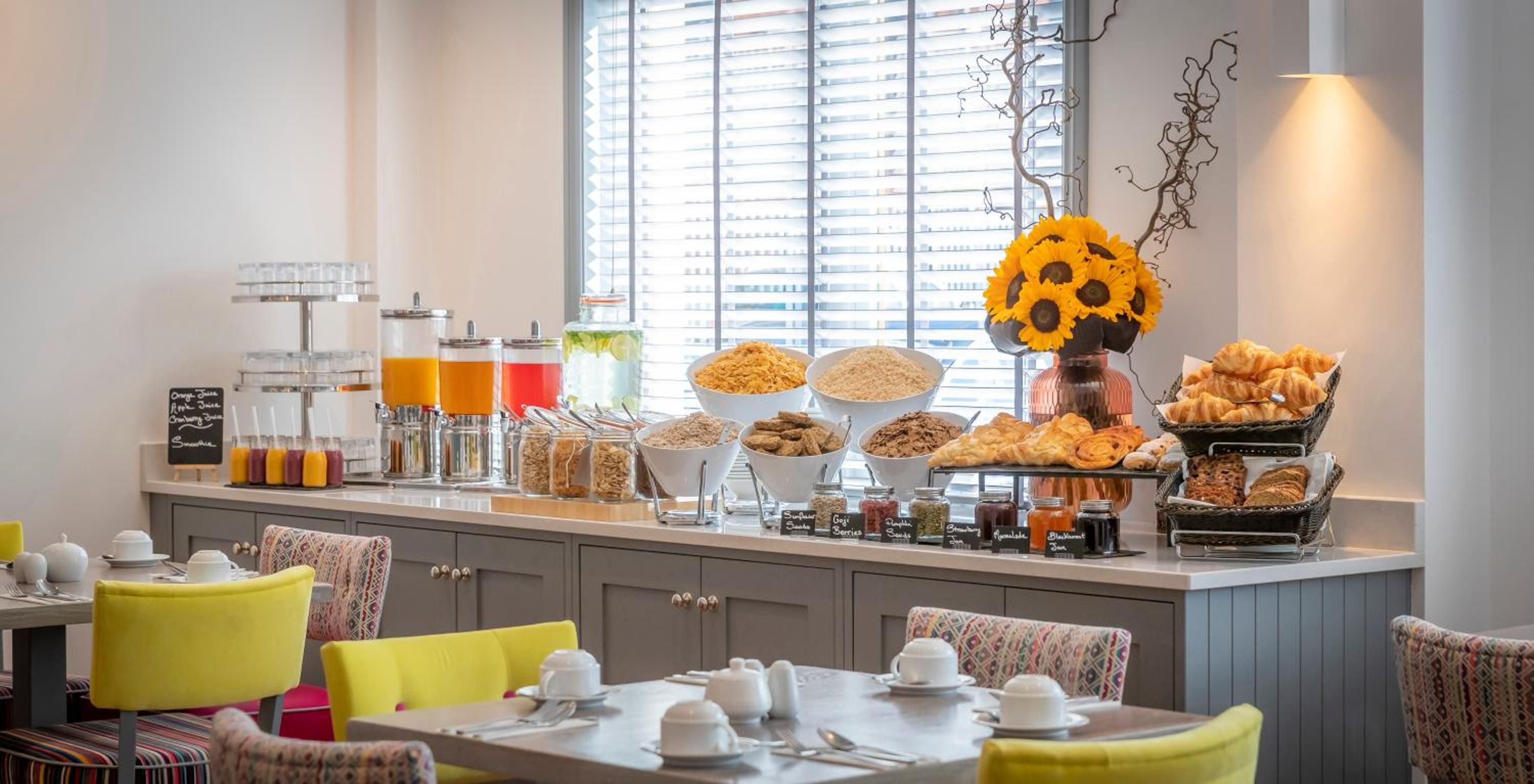 A breakfast buffet with various food items and beverages.