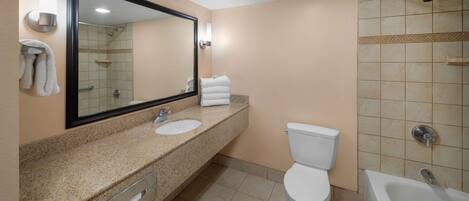 A bathroom with a sink, toilet, and bathtub.