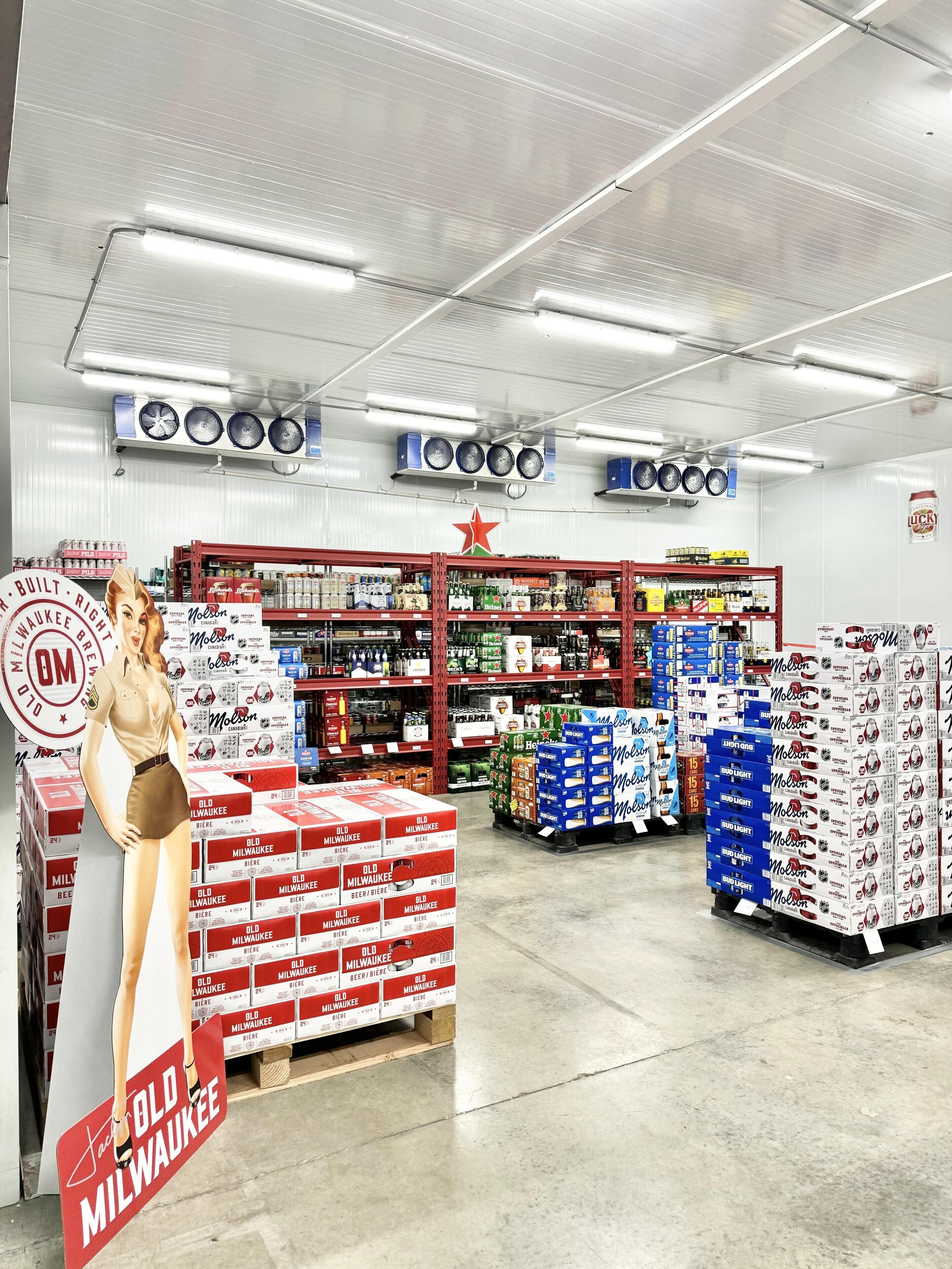 A store interior with shelves stocked with beer, prominently featuring Old Milwaukee and Bud Light.