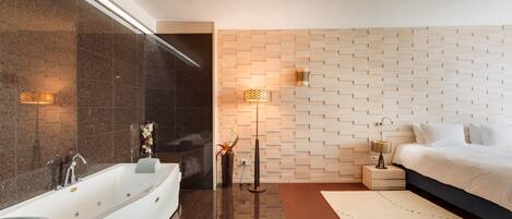 A modern bathroom with a freestanding bathtub, a large mirror, and a wall-mounted towel rack.
