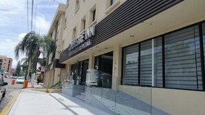 A hotel with a modern facade, large windows, and a visible entrance. - Hotel Campestre Inn (León)