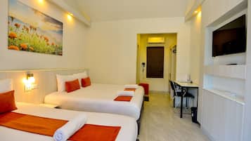 A hotel room with two beds, a desk, a TV, and a painting on the wall.