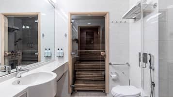 Un baño moderno con lavamanos grande, espejo, ducha y retrete.